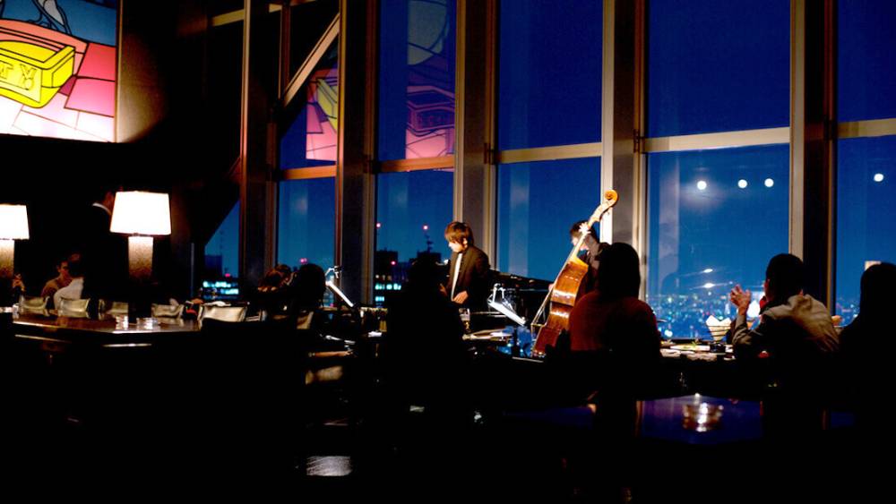 Dimly lit restaurant with musicians playing.