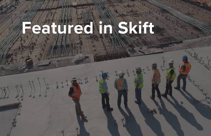 Featured in skift text with construction workers in the background.